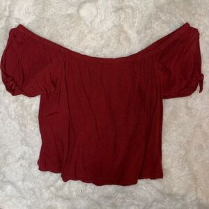 Off the shoulder, red/ maroon top with cutouts on sleeves. Size medium